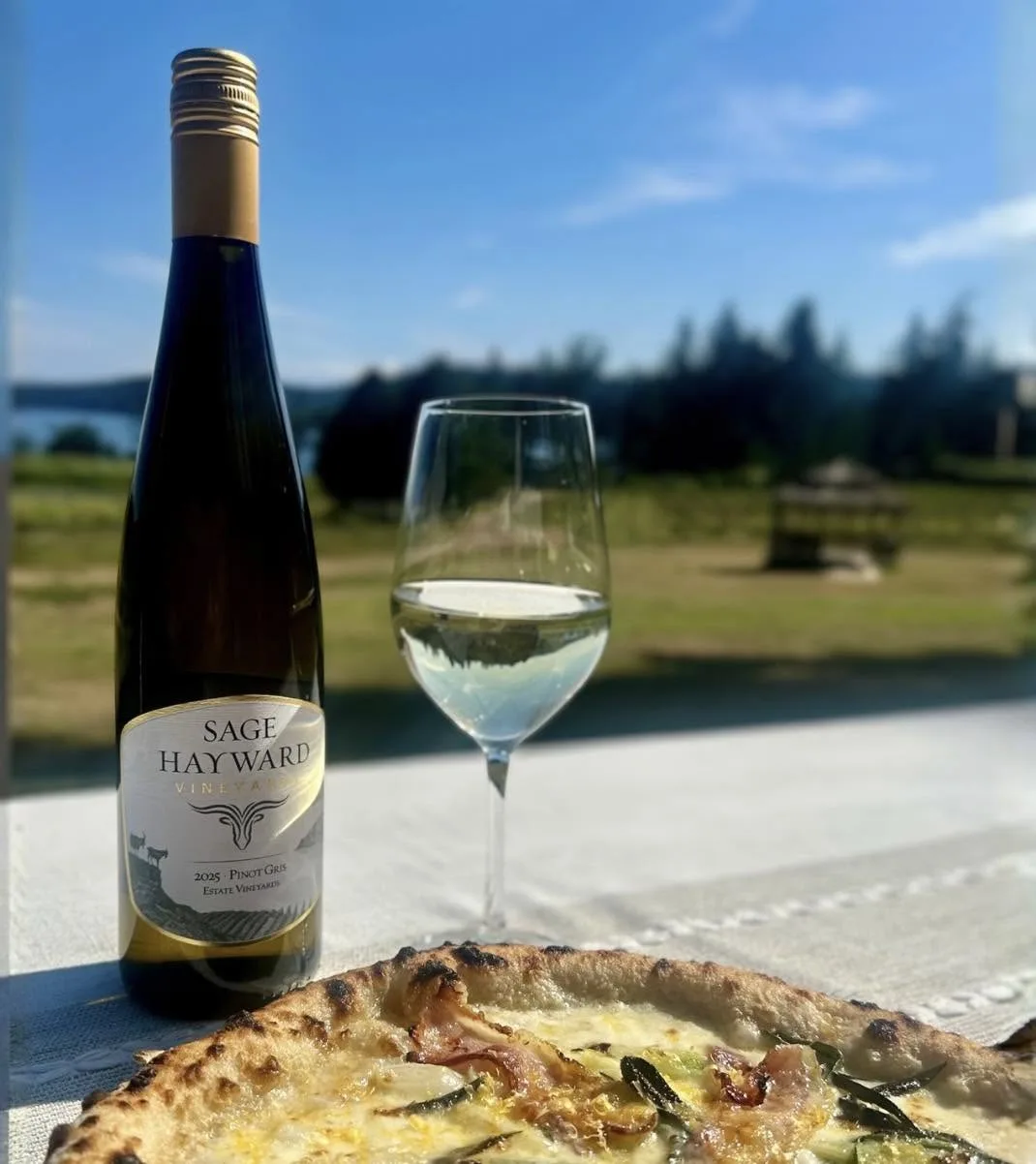 Sage Hayward wine and pizza with the farm in the background