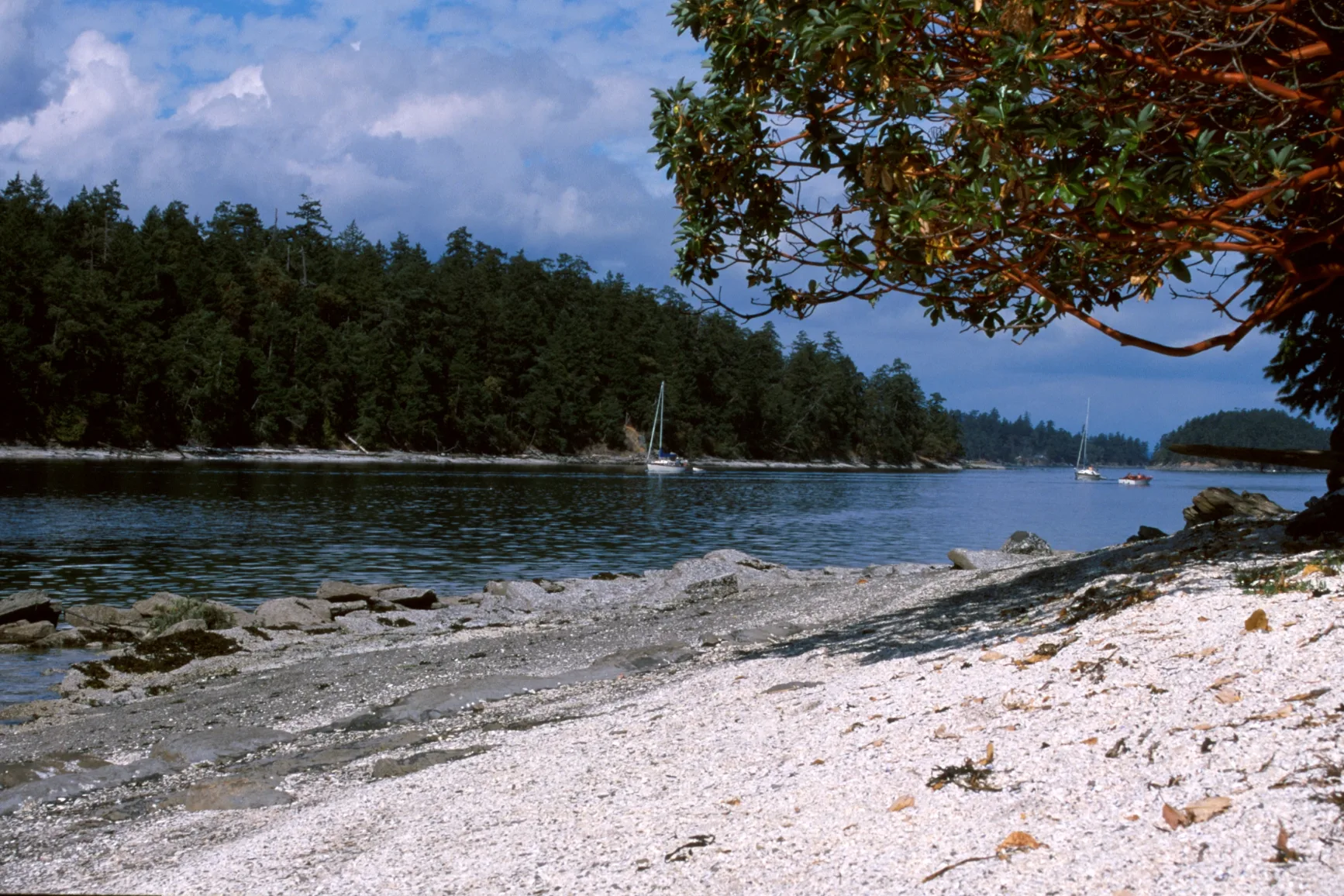 Midden beach with sail boats in the distance