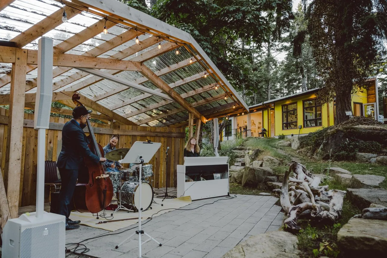 a band setting up on an outdoor deck